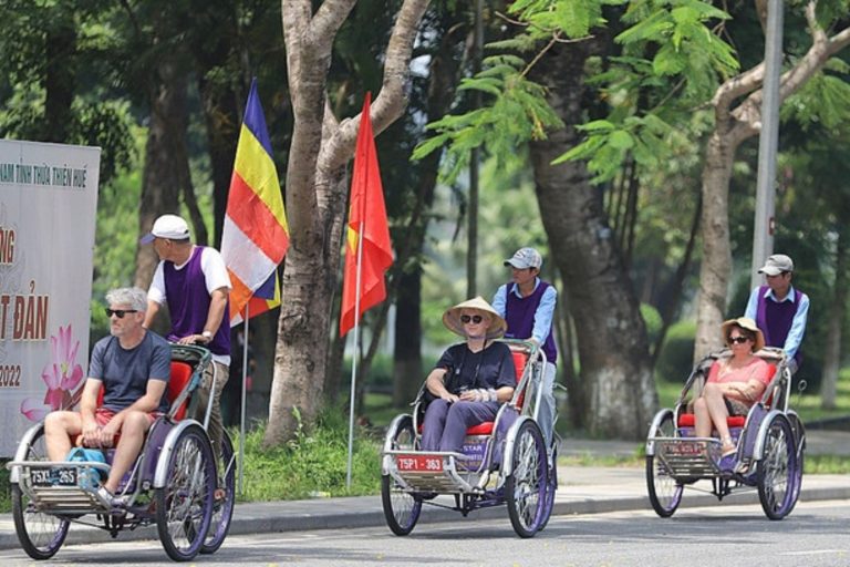 Foreign visitors experiencing the charm of Hue on a hue cyclo through small alleys
