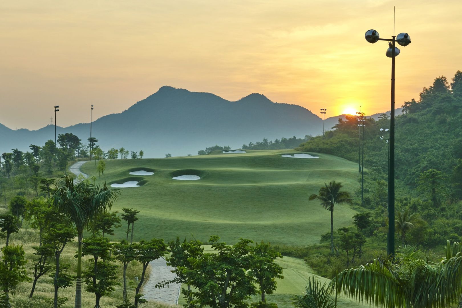 Ba Na Hills Golf Club driving range beneath the green mountains